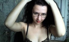 Dorky brunette in glasses chats on her live cam in her bra