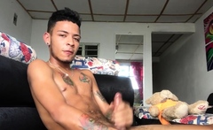 Inked Latin twink strokes his pecker